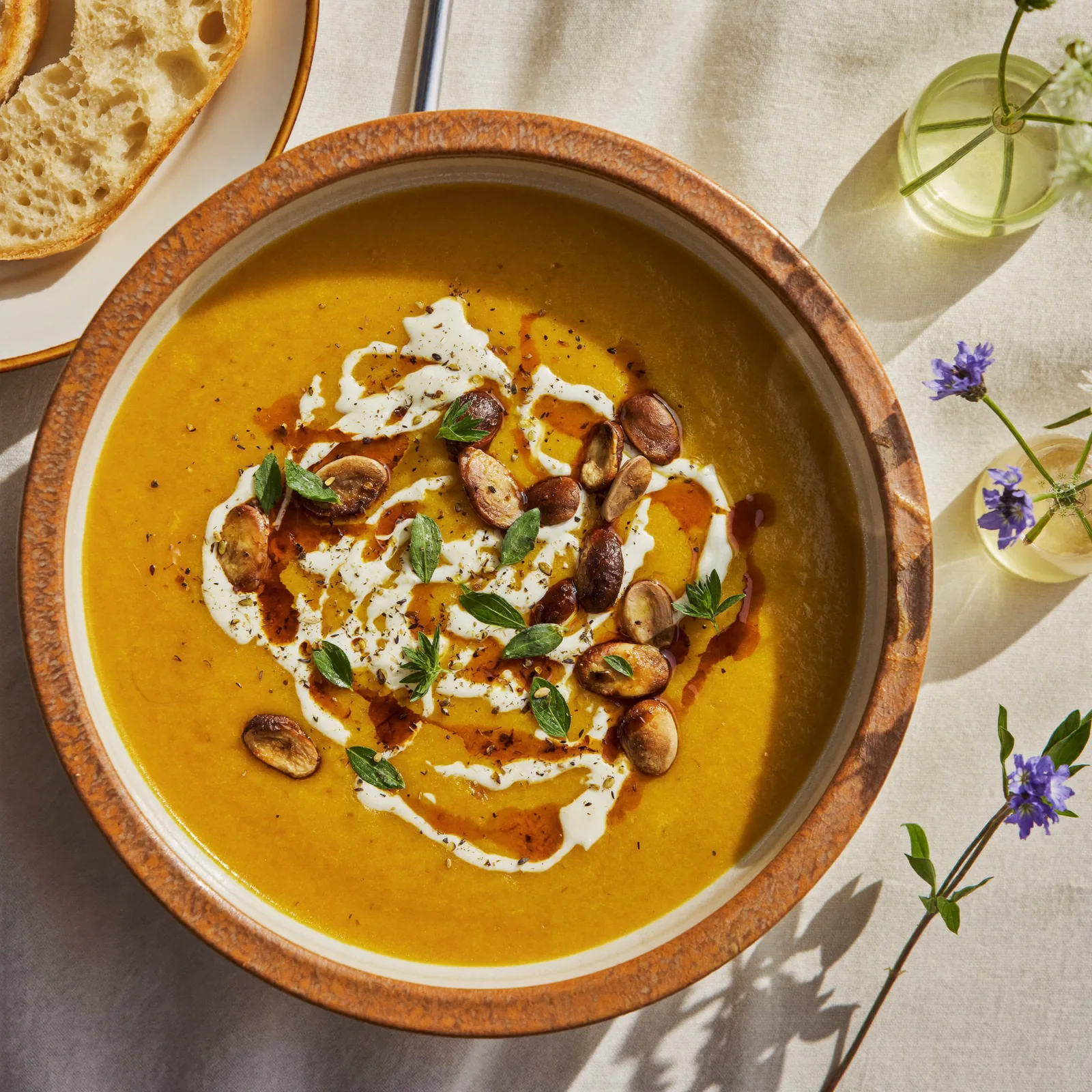 Generous bowl of golden pumpkin soup filled to the brim